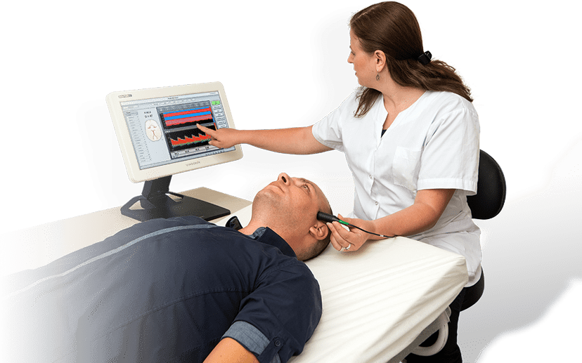 Healthcare professional performing transcranial Doppler (TCD) examination on a supine patient using the Dolphin TCD system with waveform display